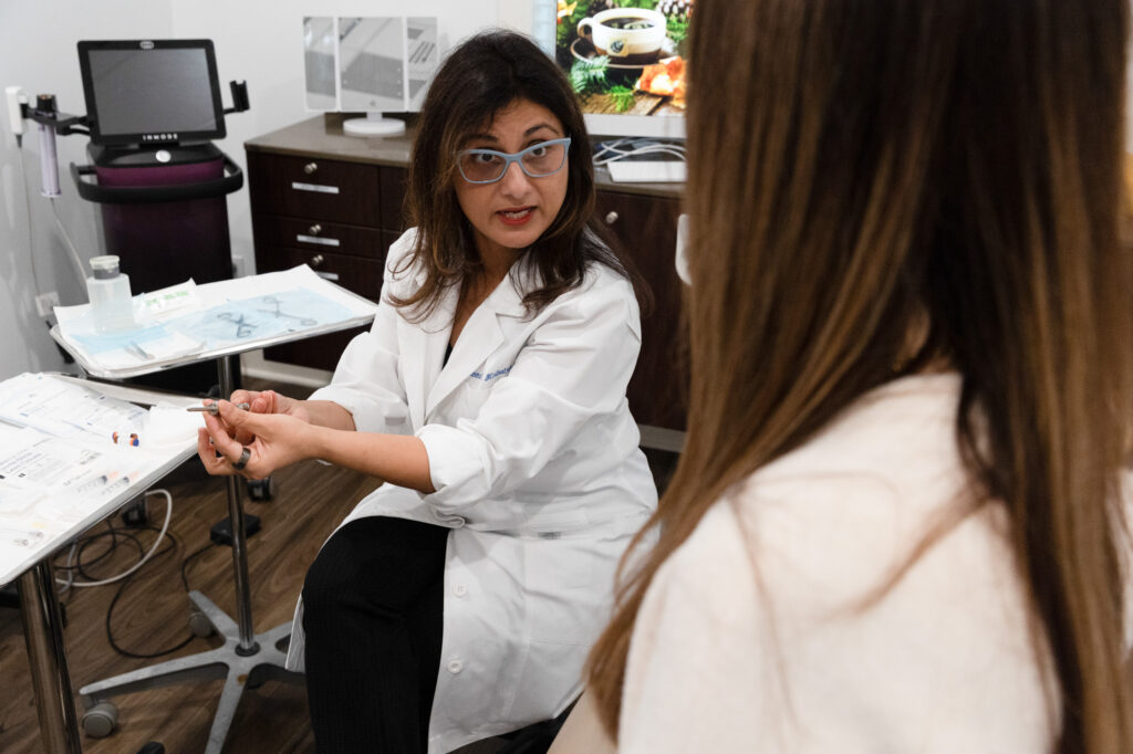Dr. Meena Malhotra tells a female patient about hormone replacement therapy at Heal n Cure, a women's health clinic in Glenview.